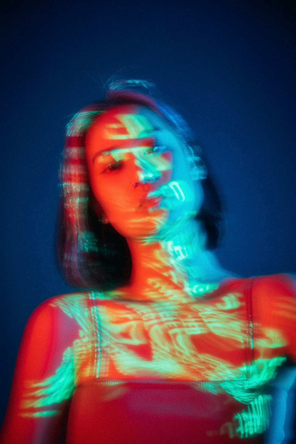 woman in red tank top with blue and white face mask