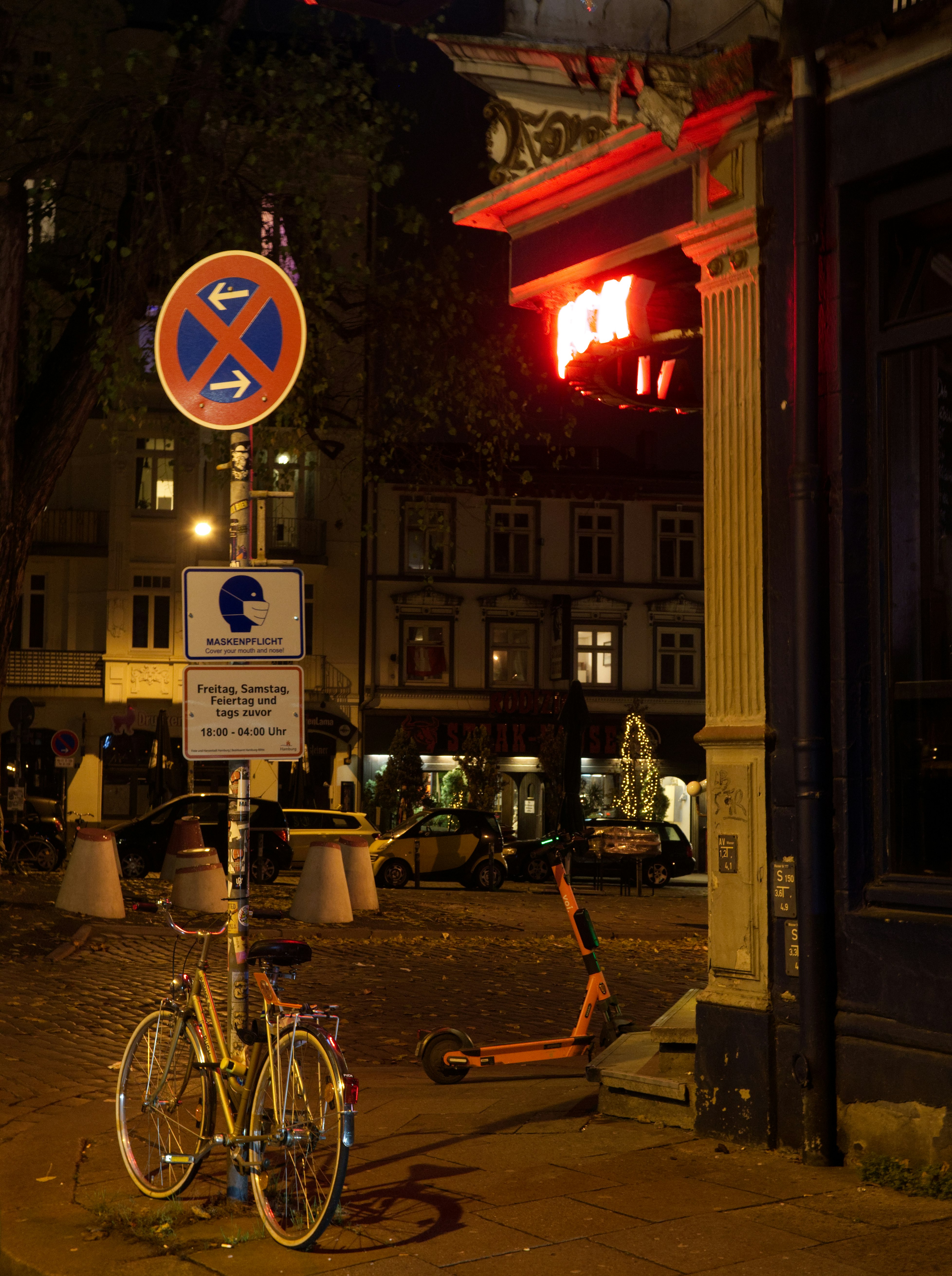 bicycle parked beside store front during night time