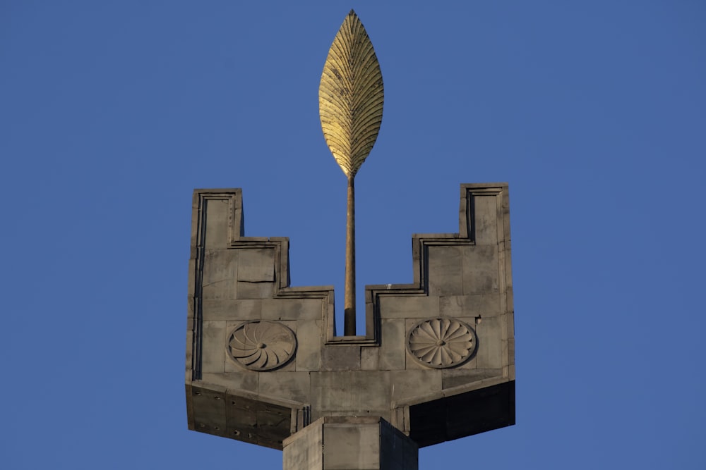 gray concrete cross with gold umbrella
