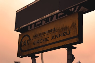Photo of a vintage tire shop sign from the 1980s representing the company’s early days.