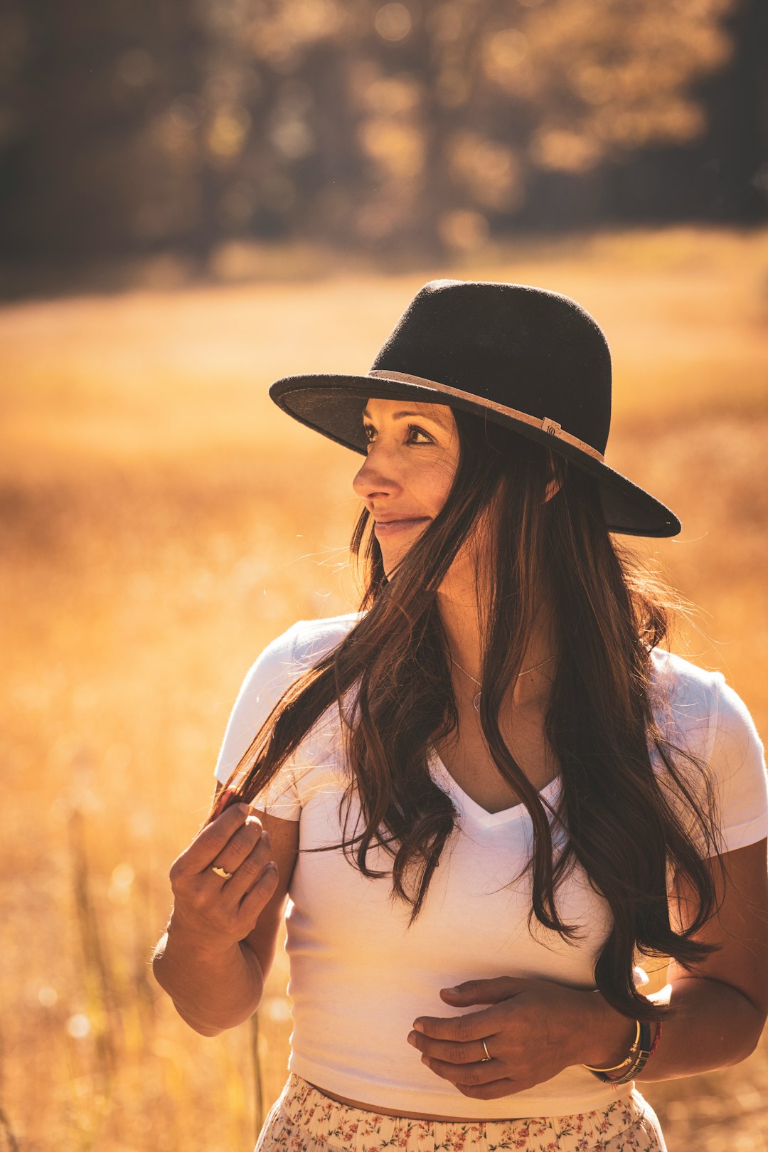 woman in white shirt wearing black hat