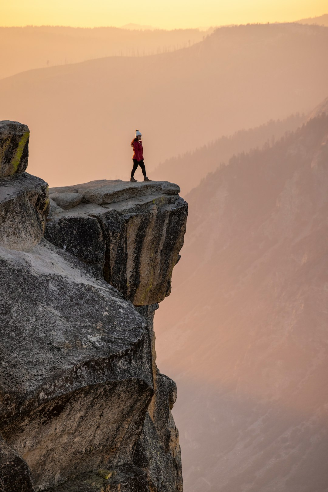 person standing on gray rock during daytime