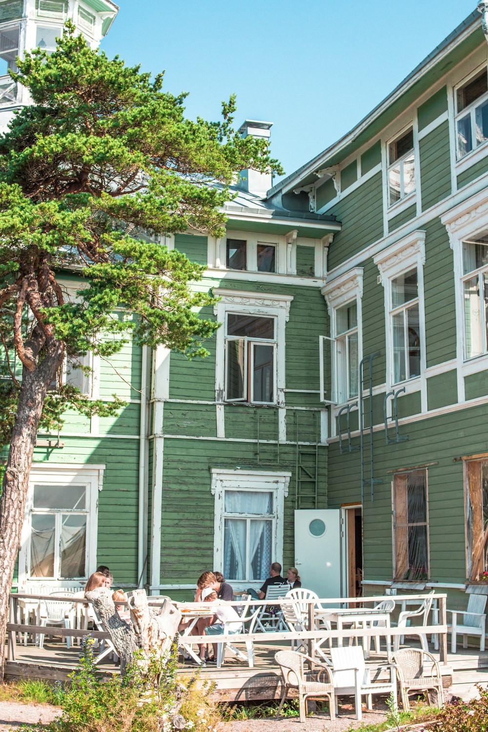 people sitting on bench near brown and white concrete building during daytime