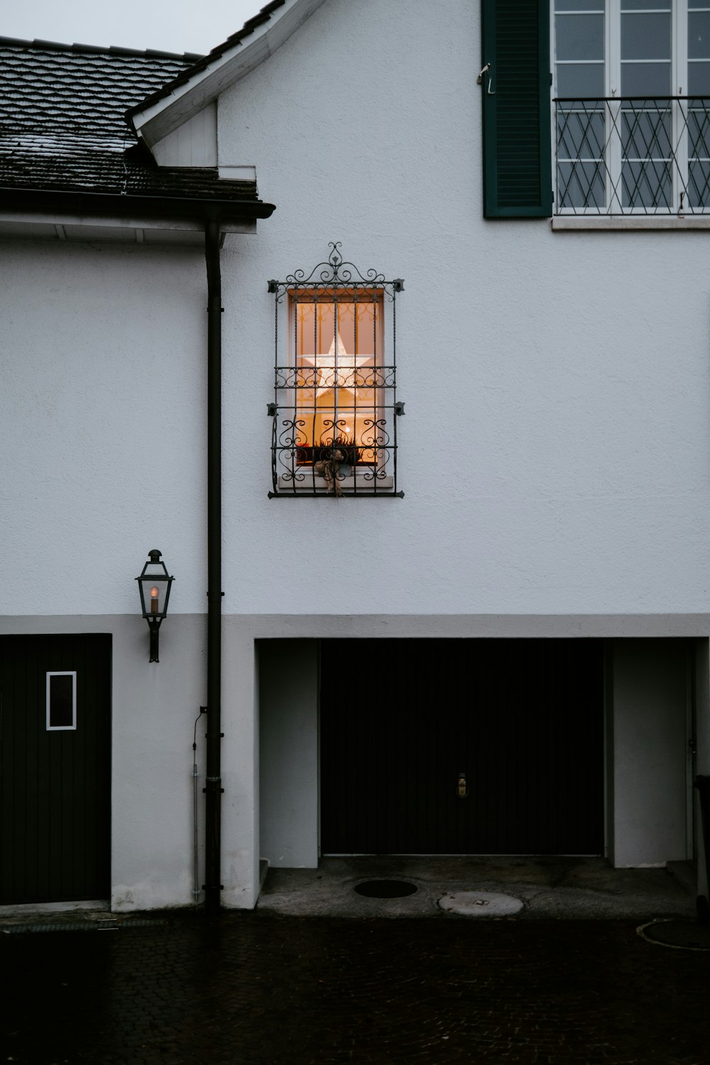 black sconce lamp on white concrete building