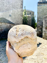 A warm, inviting photo of hands exchanging a loaf of bread symbolizing hope and connection.