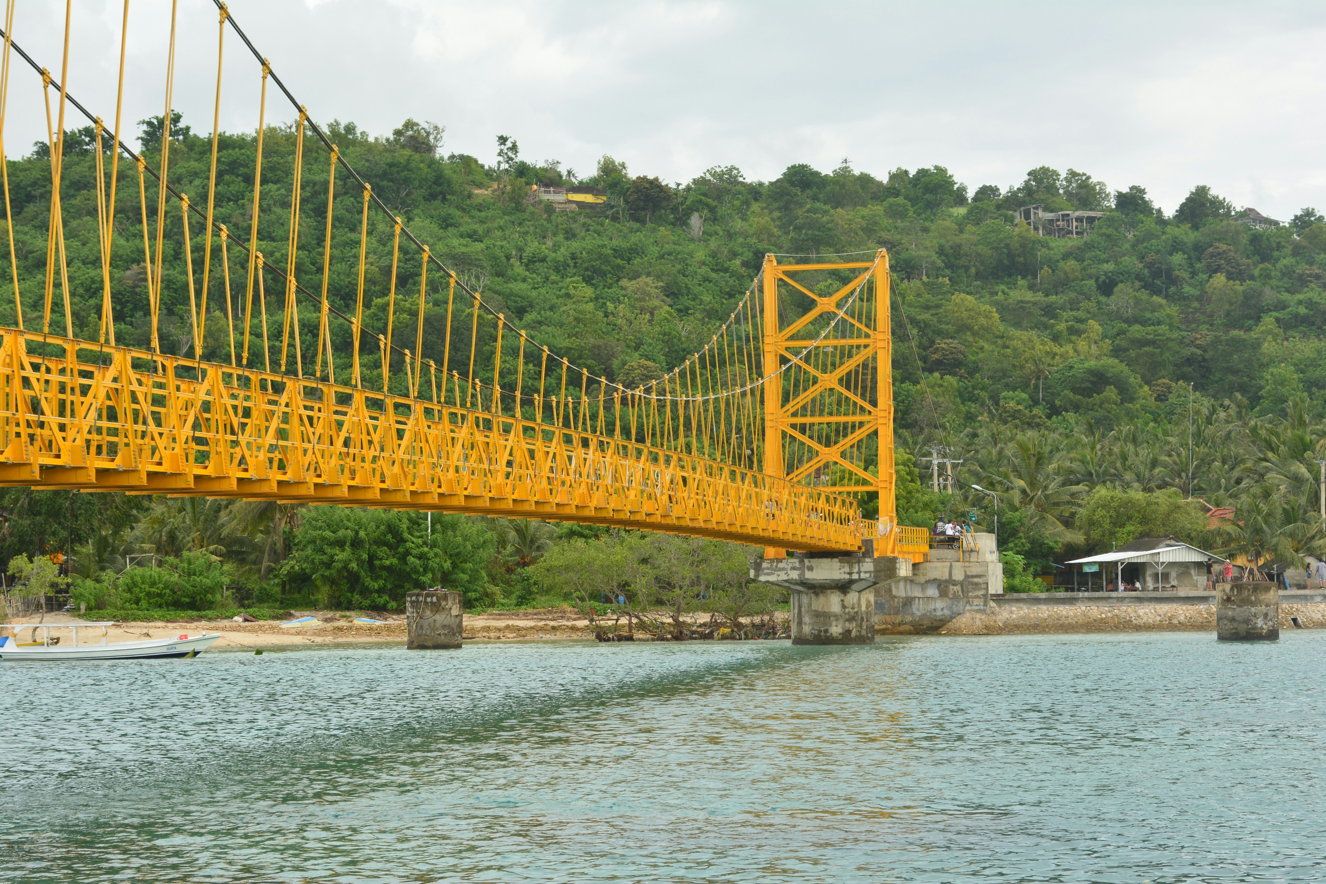 green bridge over river during daytime