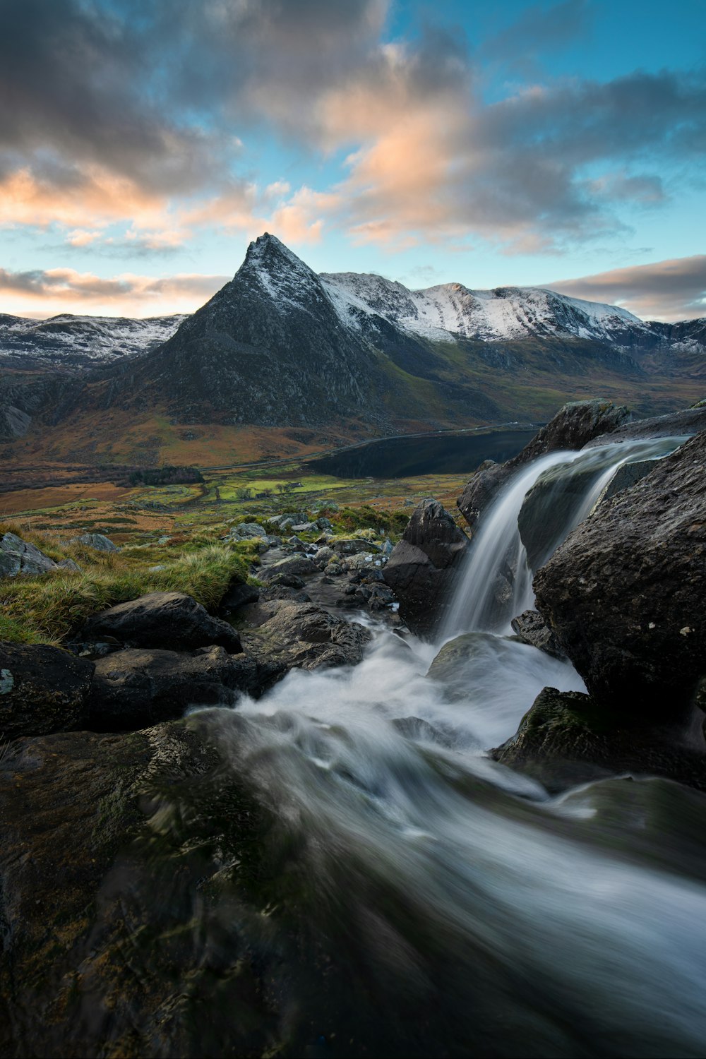 water falls on rocky mountain during daytime