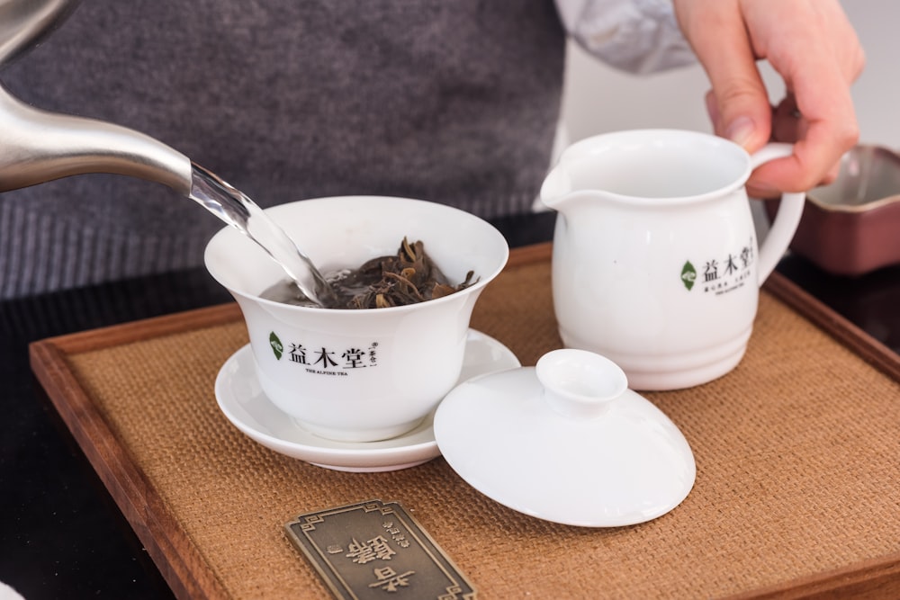 white ceramic teacup on brown wooden table