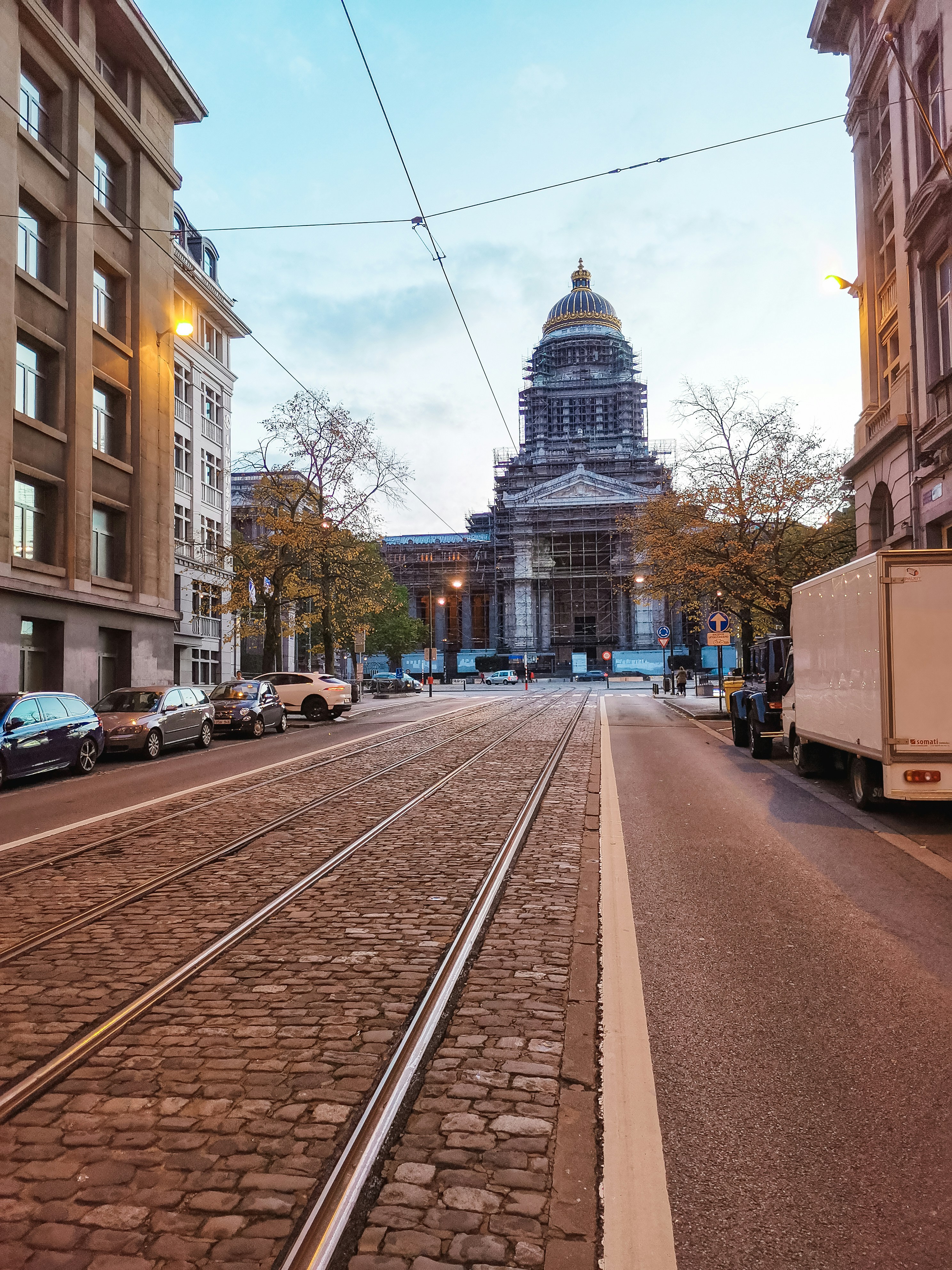 cars parked on side of road near buildings during daytime