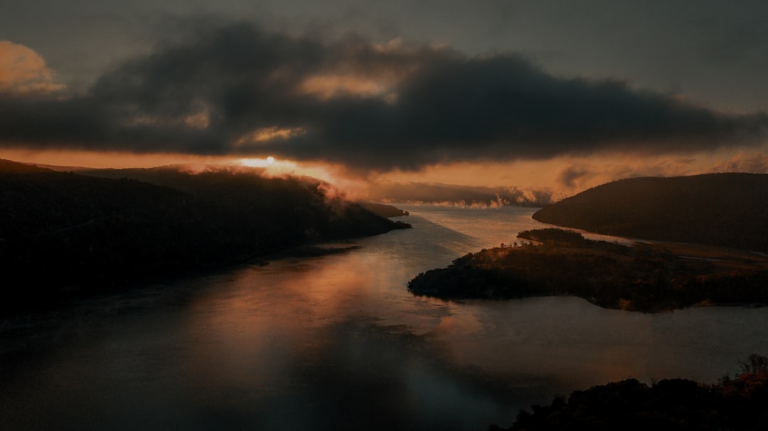 body of water under cloudy sky during daytime