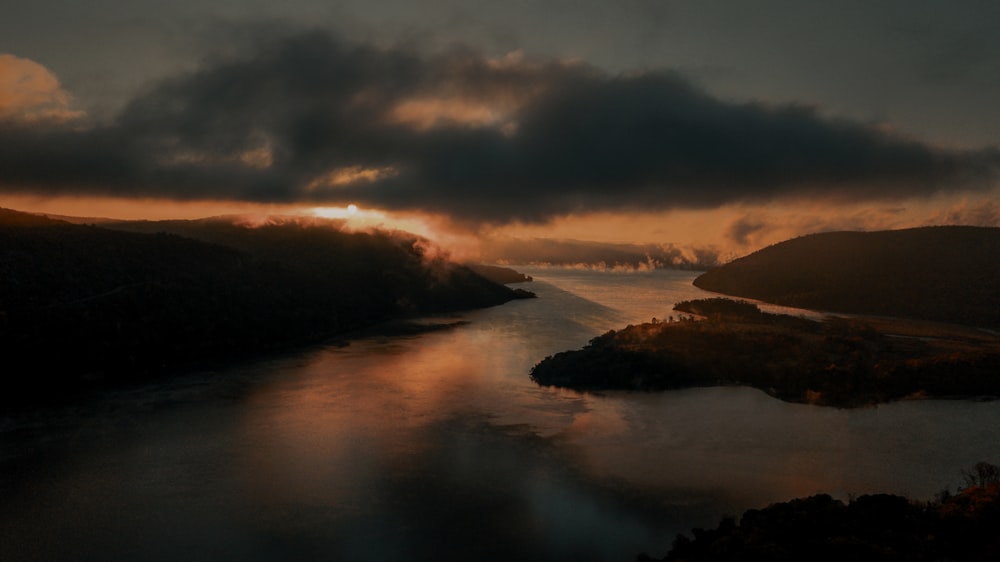 body of water under cloudy sky during daytime