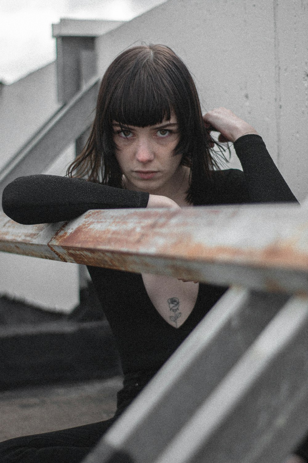 woman in black long sleeve shirt sitting on brown wooden bench