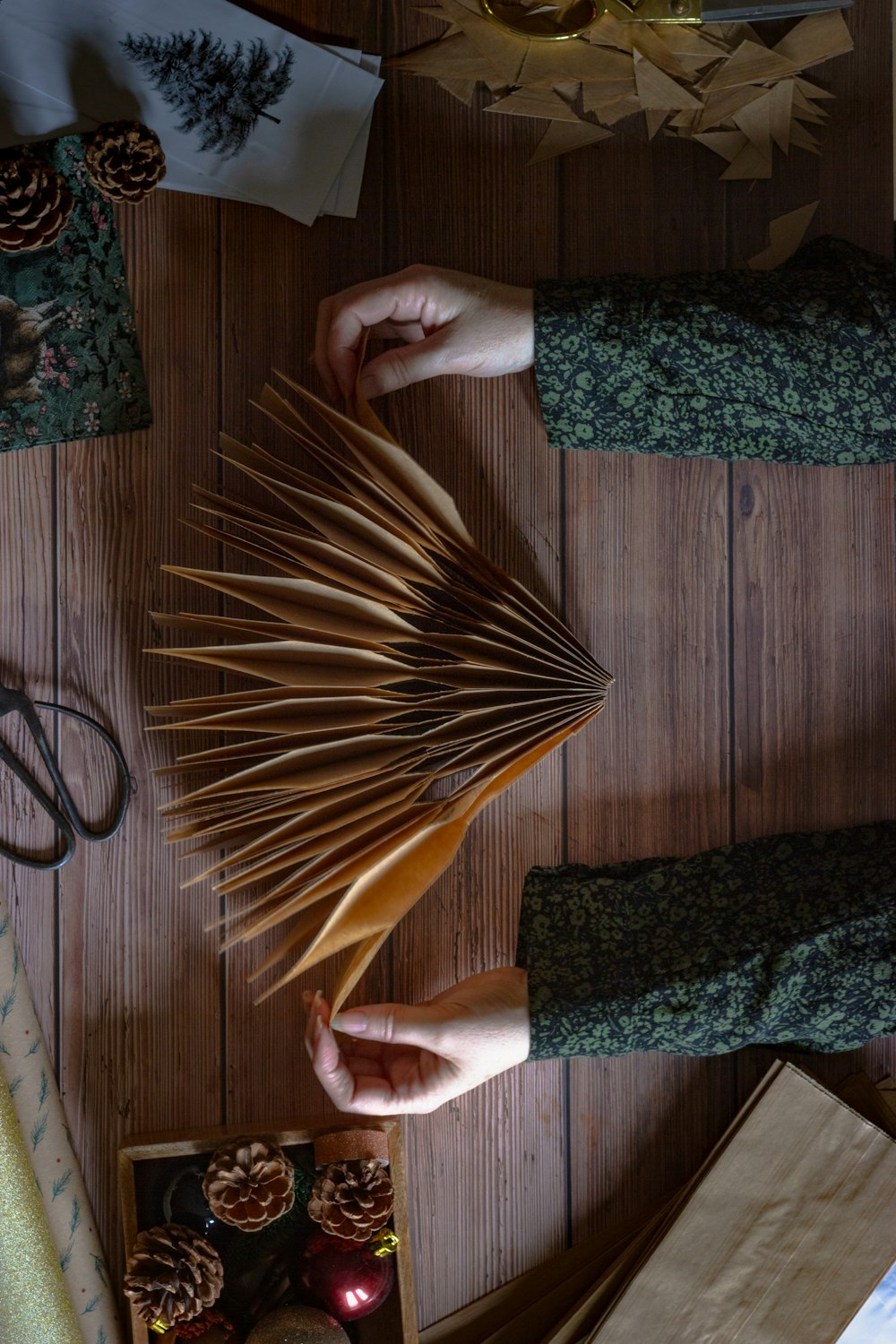 person holding brown and beige hand fan