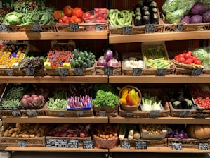 assorted fruits on brown wooden rack