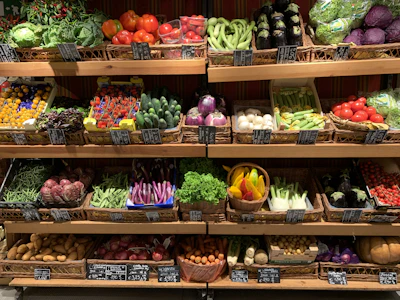 assorted fruits on brown wooden rack