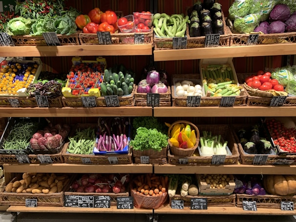 assorted fruits on brown wooden rack