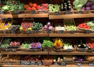 assorted fruits on brown wooden rack