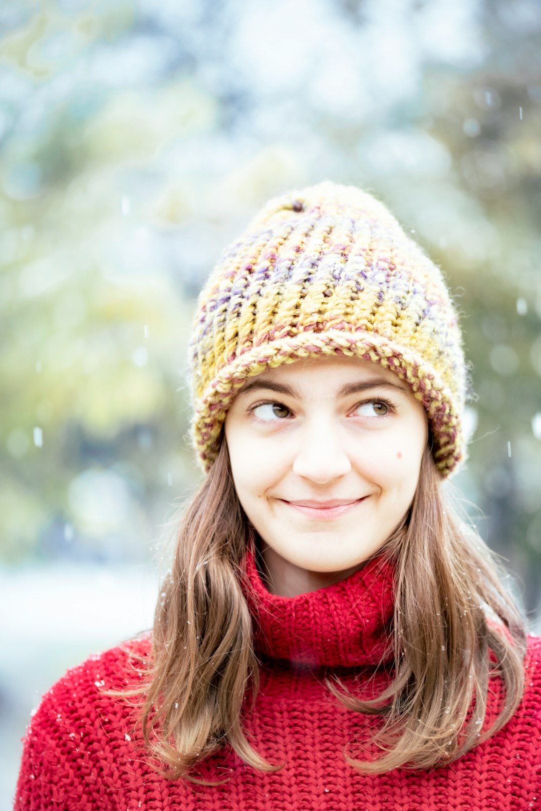 girl in red scarf and brown knit cap