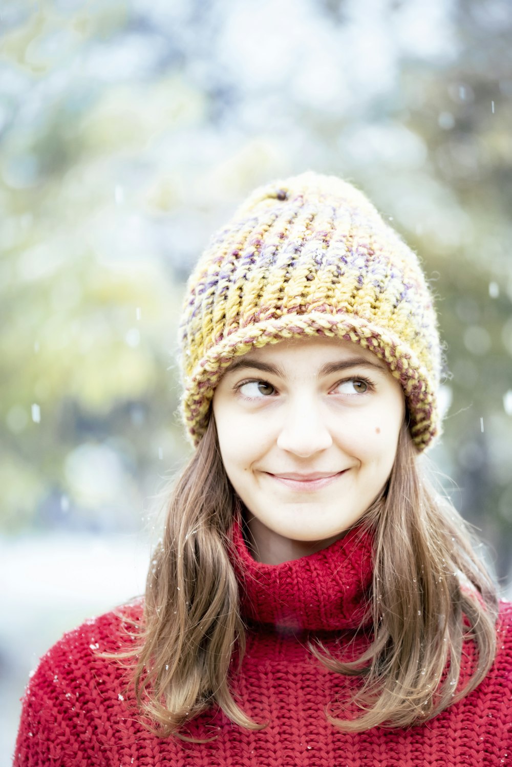 girl in red scarf and brown knit cap