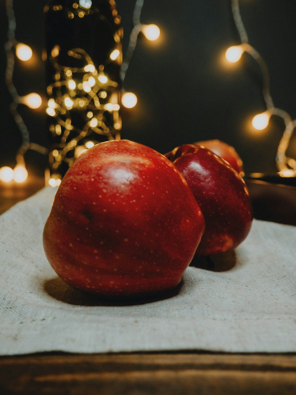 red apple fruit on white textile