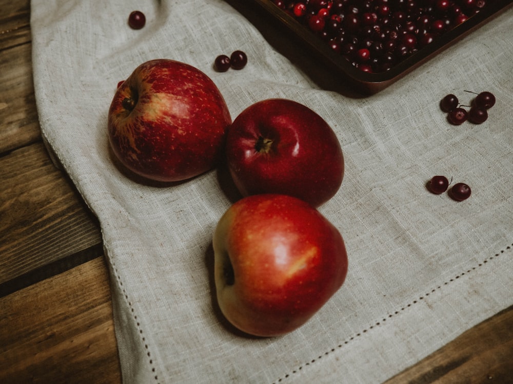 red apples on white textile