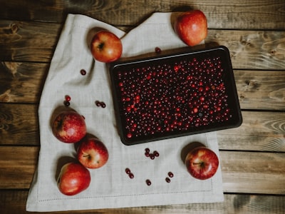 red apple fruit on black tray cranberries zoom background