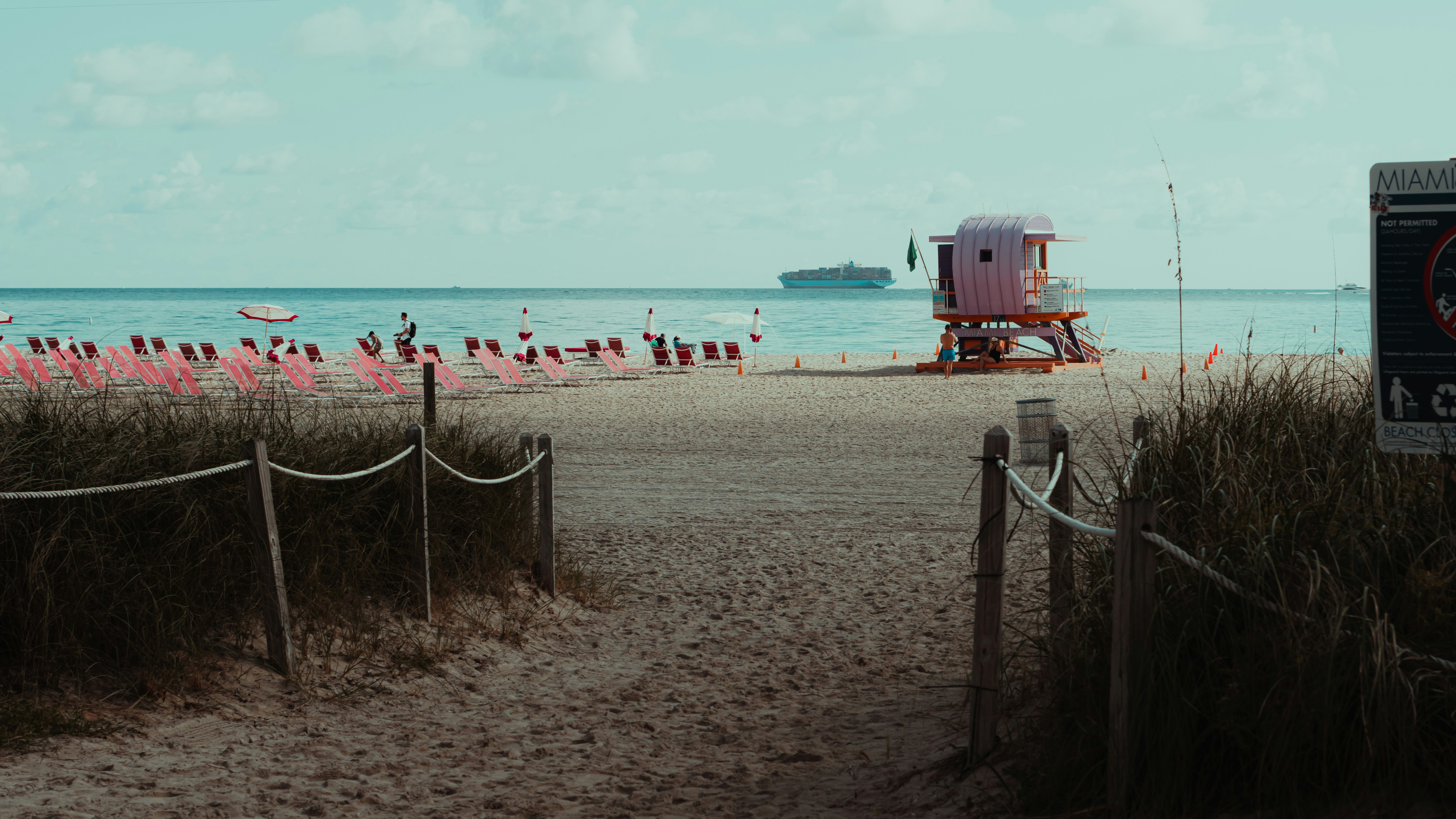 red and blue truck on beach during daytime