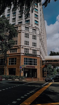A panoramic view of a modern international hospital with welcoming staff at the entrance.