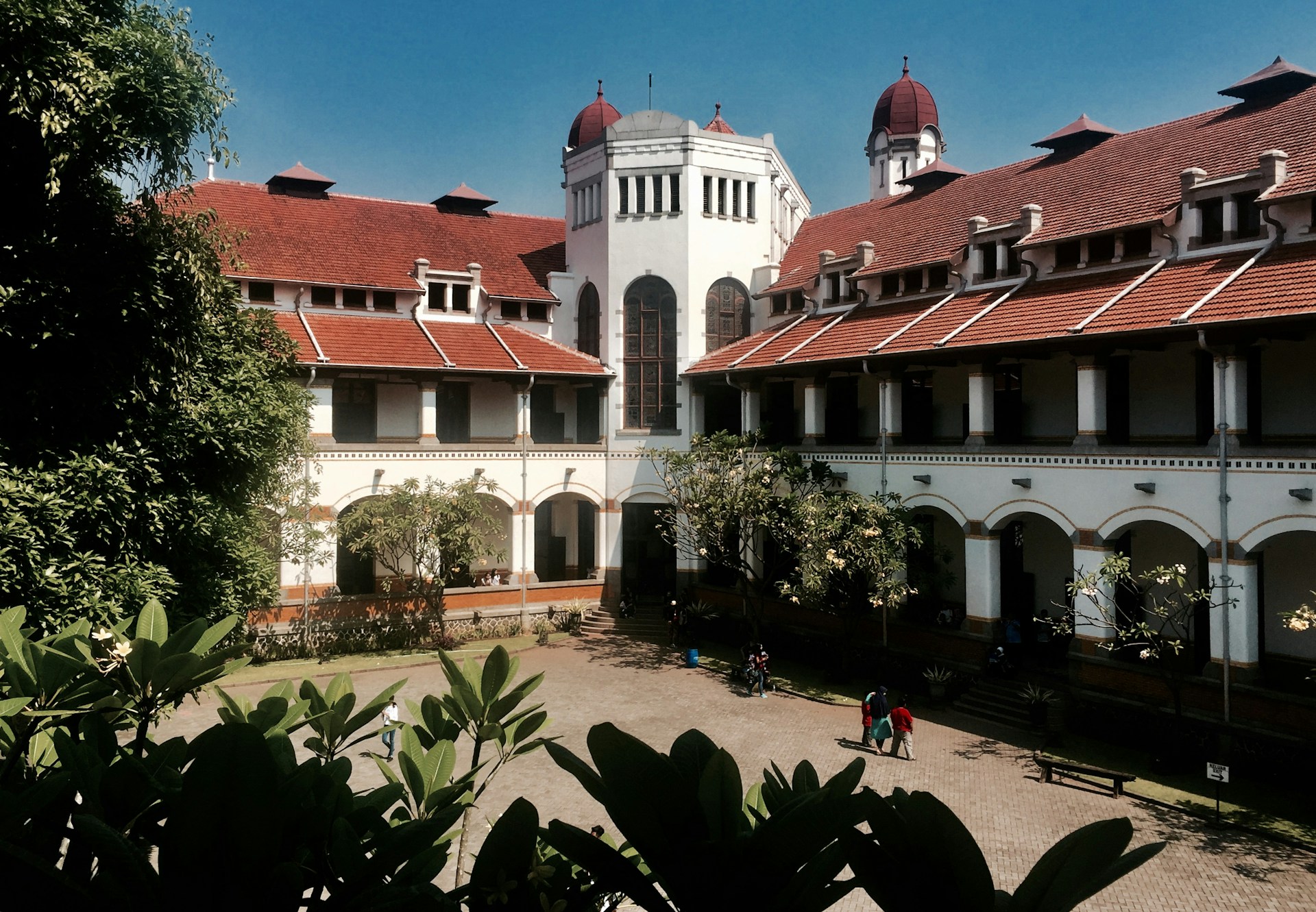 people walking on street near white and brown concrete building during daytime