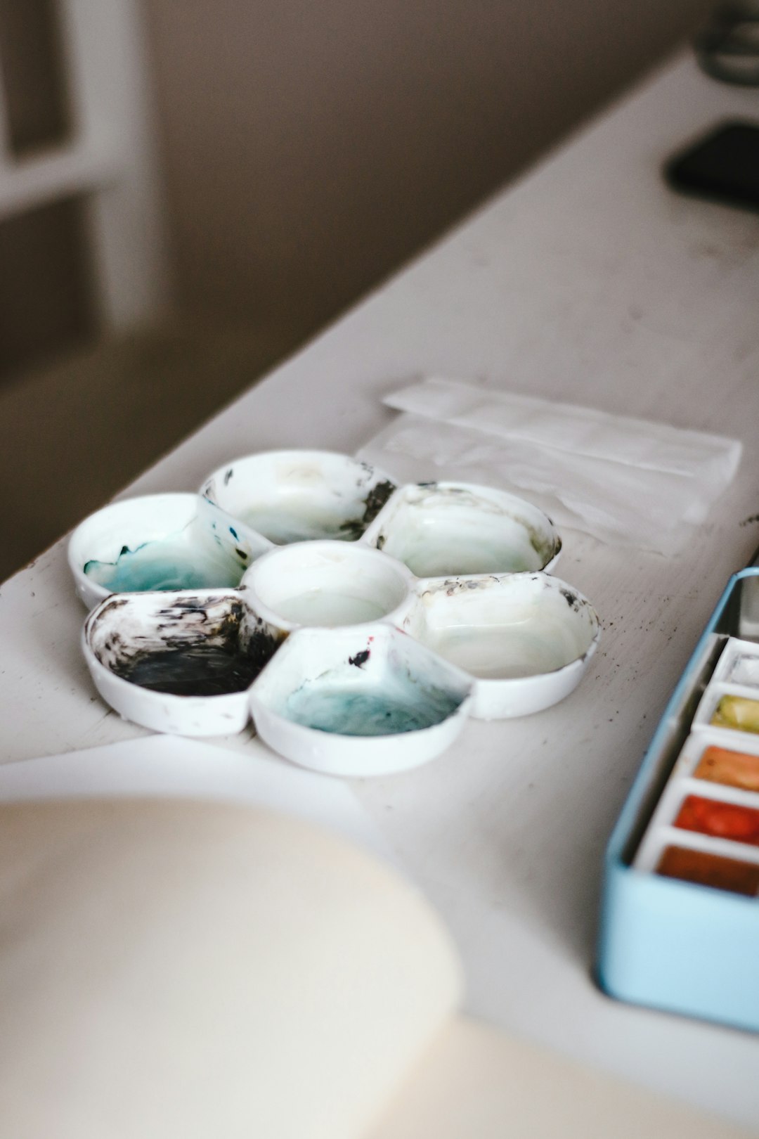 white and green ceramic bowl on white table