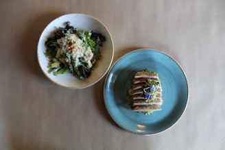 An overhead shot of a balanced lunch plate with greens and protein.