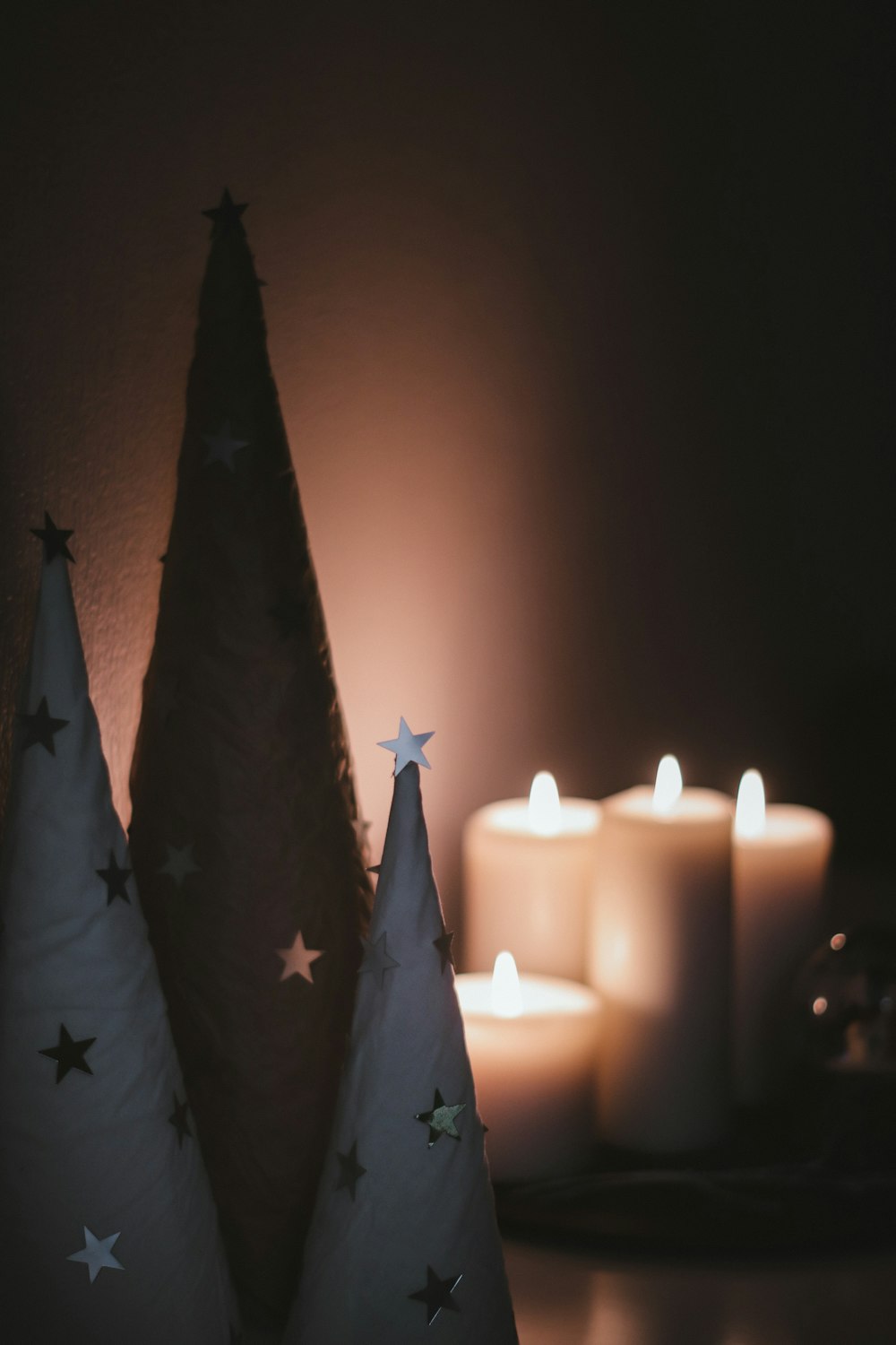 white lighted candles on black and white textile