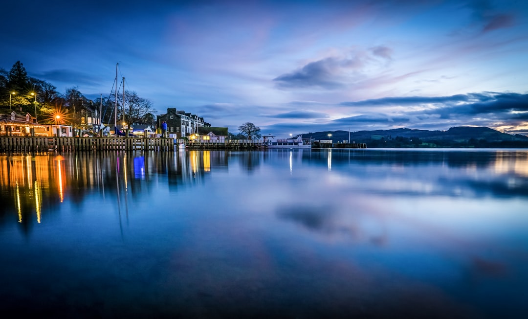 city skyline across body of water during night time