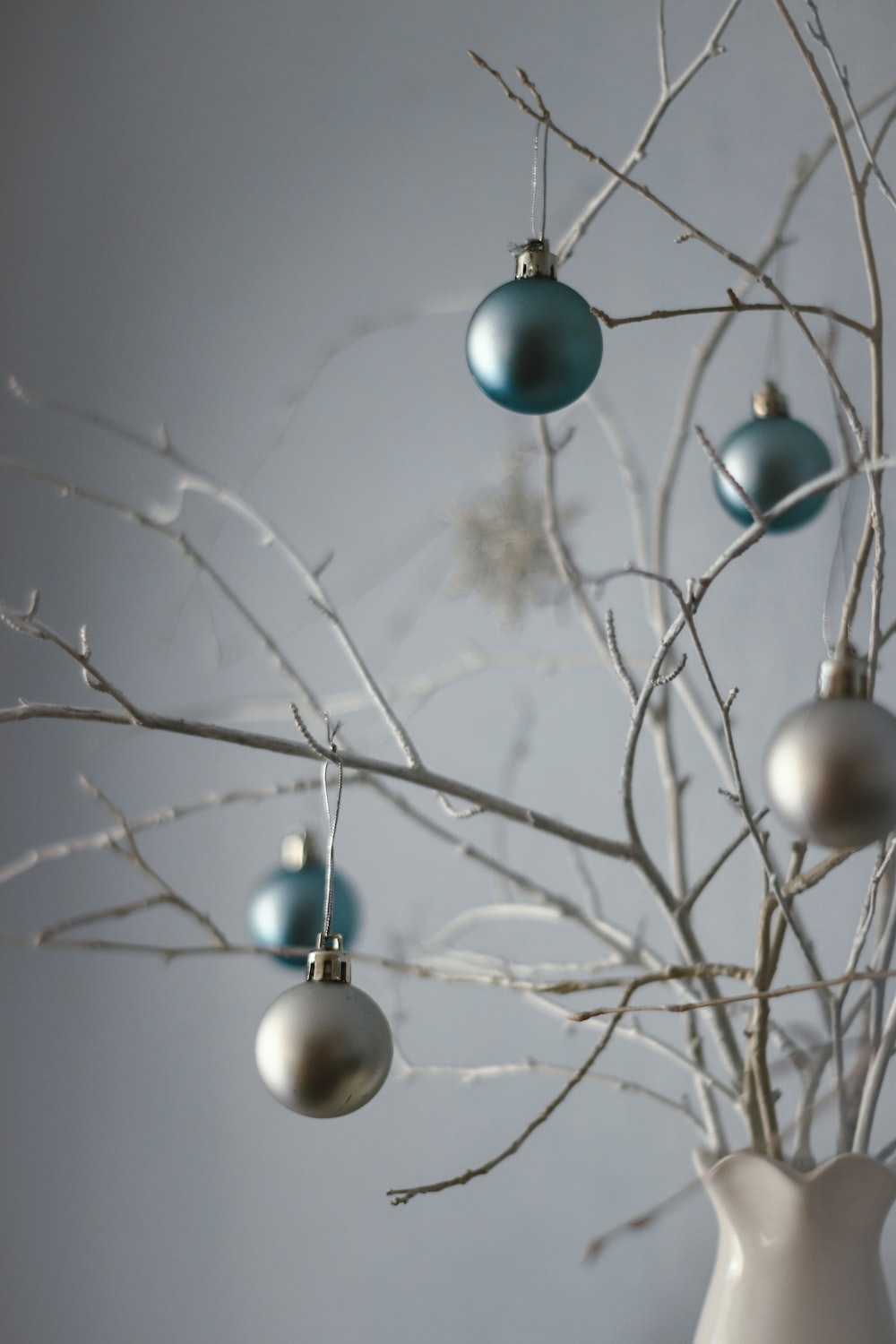 blue and white baubles on tree branch