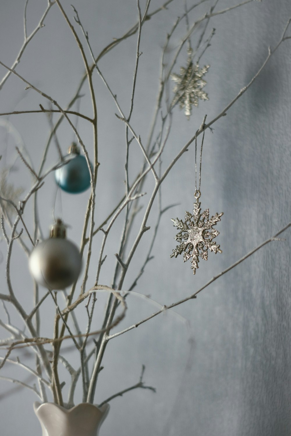 white and blue baubles on white tree branch