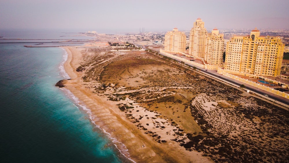 aerial view of city buildings near body of water during daytime