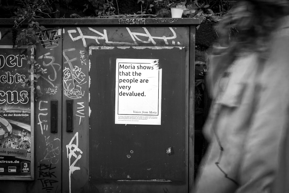 grayscale photo of black wooden door