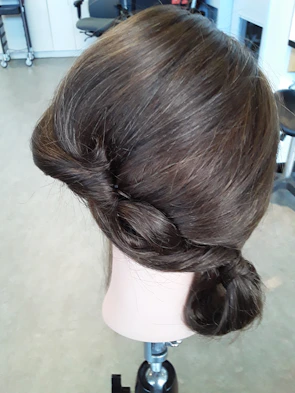 Elegant mannequin head showcasing a voluminous, styled wig.