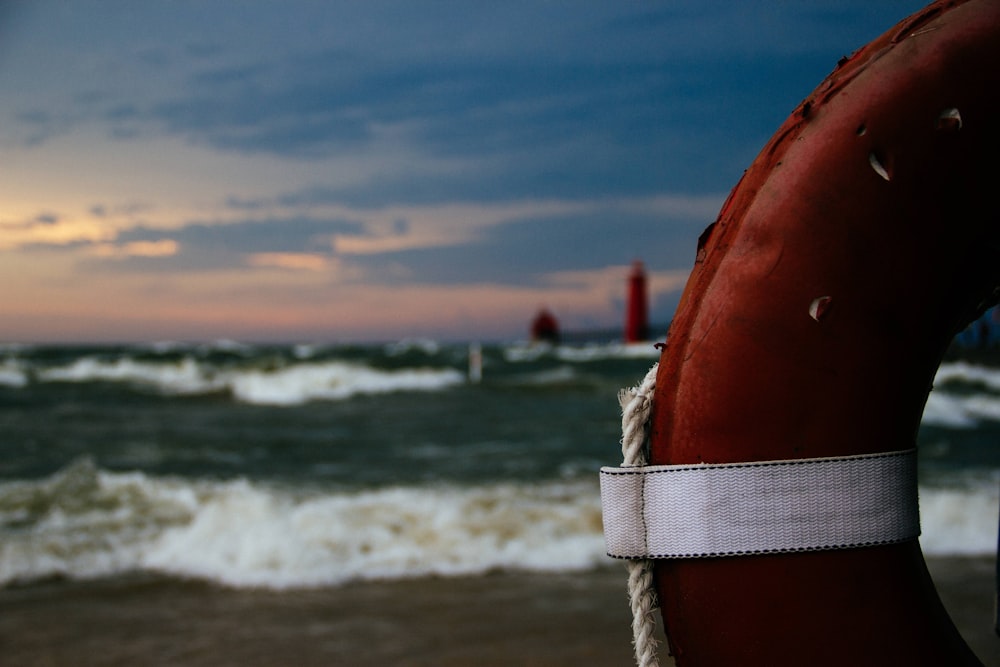 red and white inflatable ring on beach shore during daytime