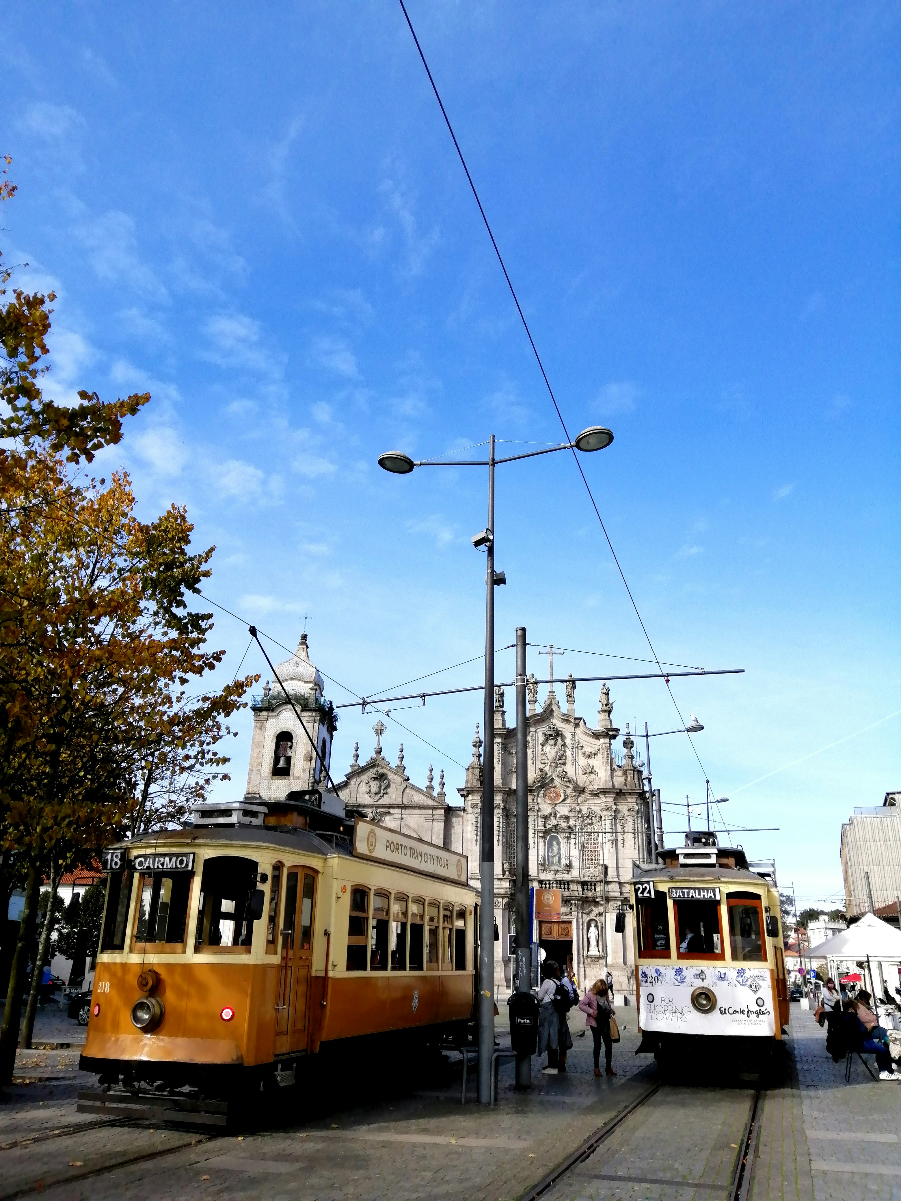 brown and black tram on the street during daytime