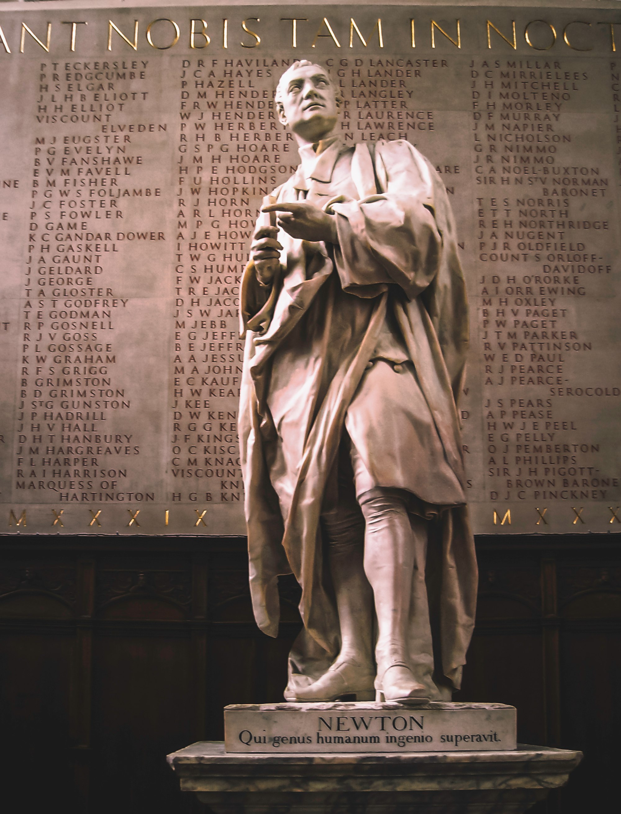A marble statue of Sir Isaac Newton, natural philosopher, mathematician, and scientist in Trinity College anti-chapel at Cambridge University. The inscription below translates to " In intellect he surpassed the human race," which is a quote from the Lucretius, "De Rerum Natura." (Mar., 2008)