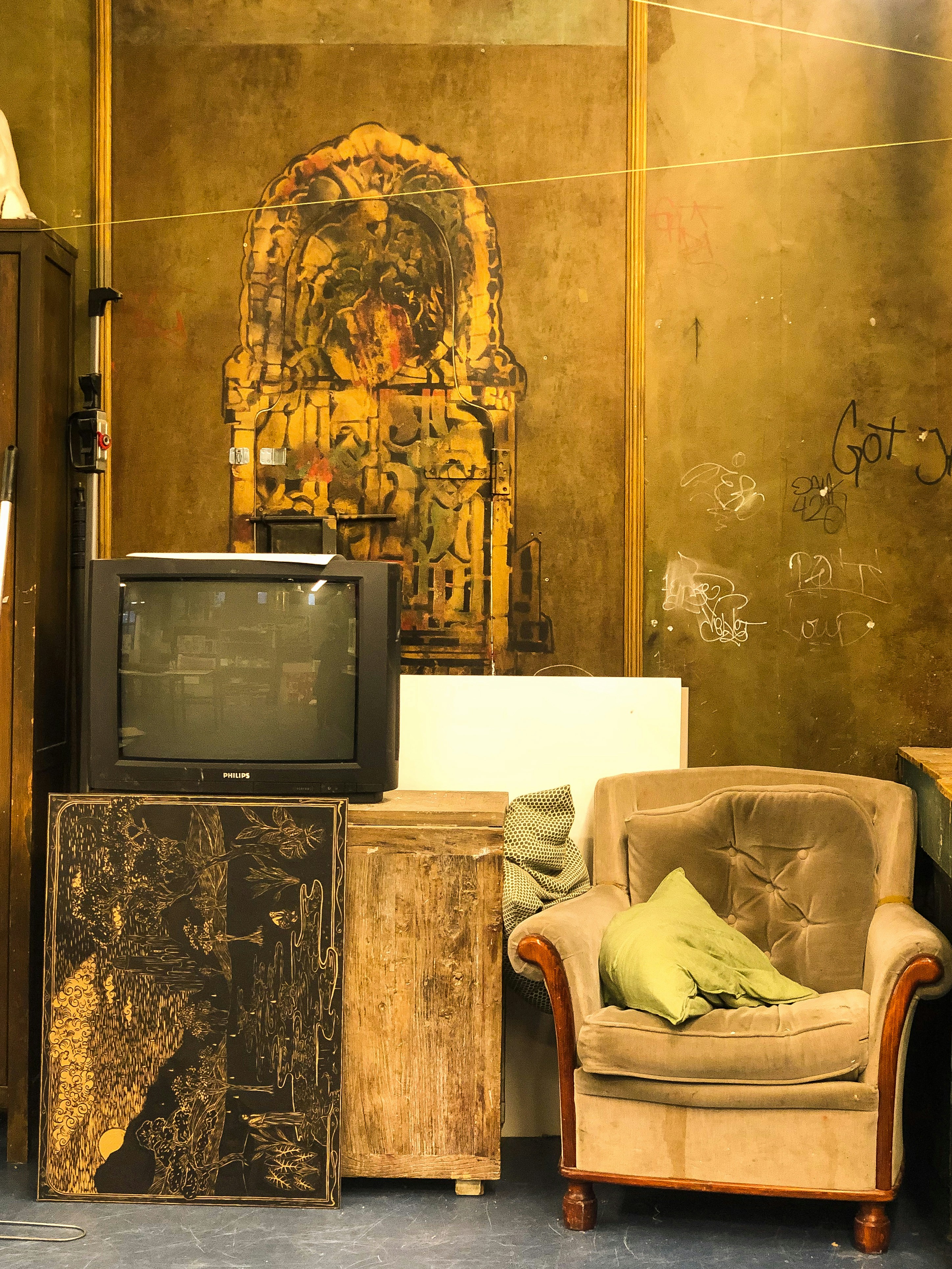 black crt tv on brown wooden tv rack