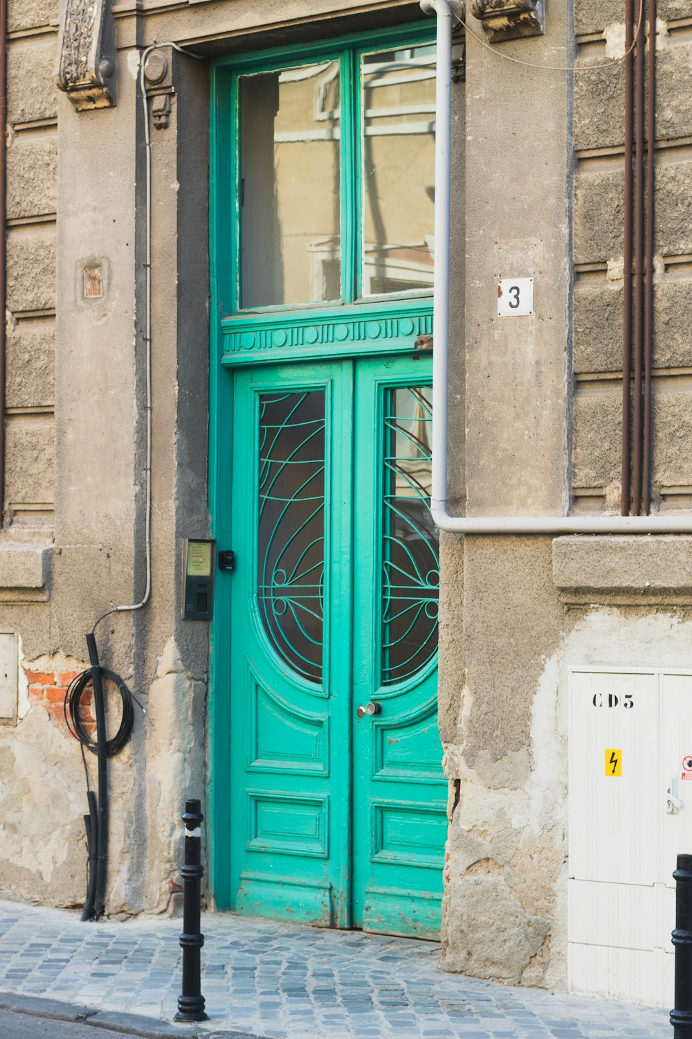 blue wooden door on gray concrete wall