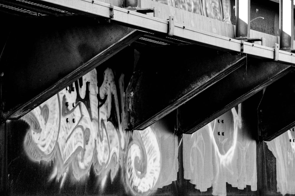 grayscale photo of a wall with graffiti