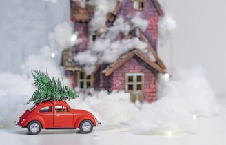 red car in front of brown house