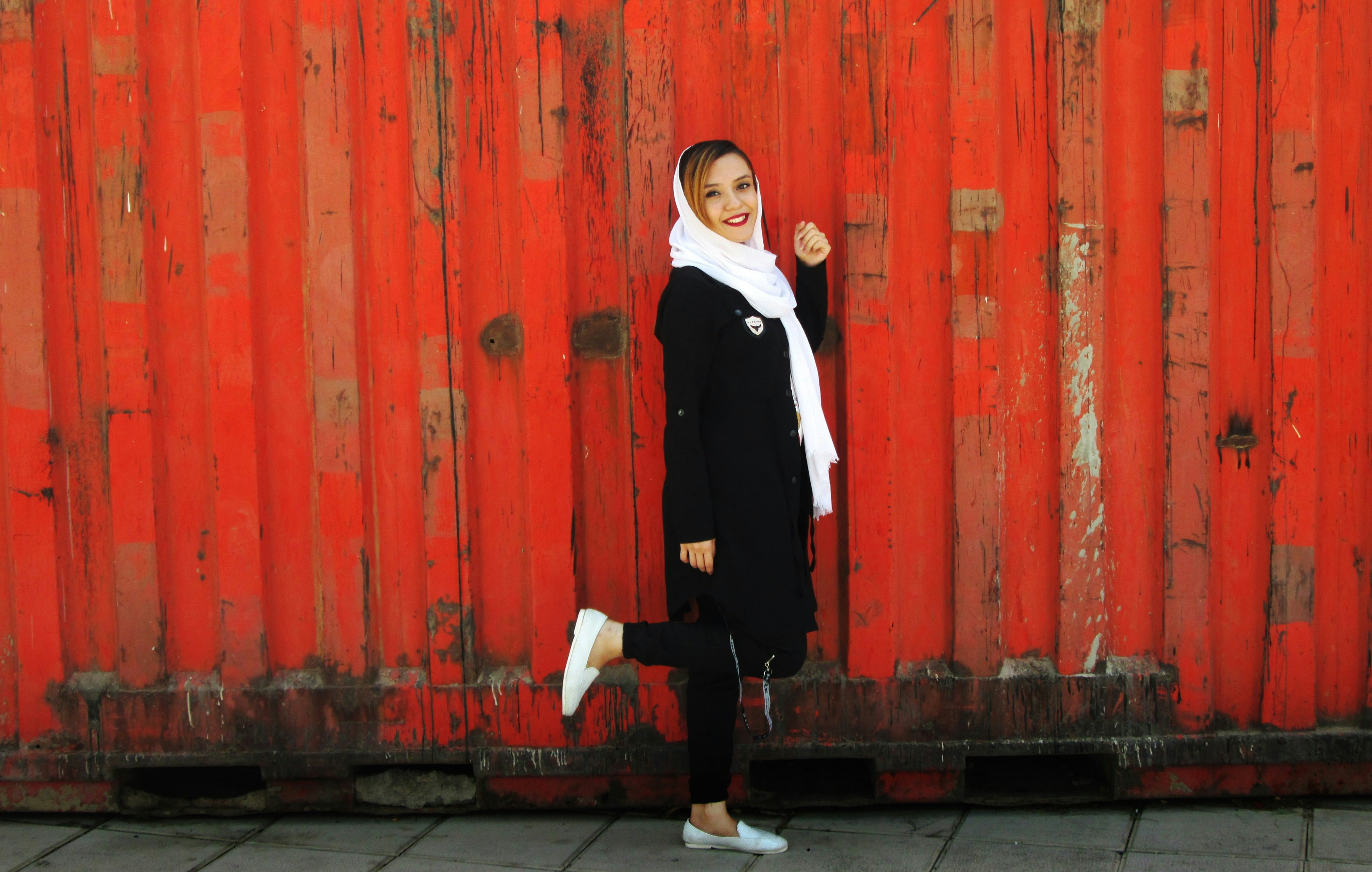 a girl with white shoes and scarf