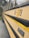The image is a close-up of a yellow school bus with the number 06-378 and a CE 300 badge displayed prominently. The bus features a distinctive yellow color with a black horizontal stripe. The windows of the bus are visible at the top portion, along with surrounding greenery reflected on them.