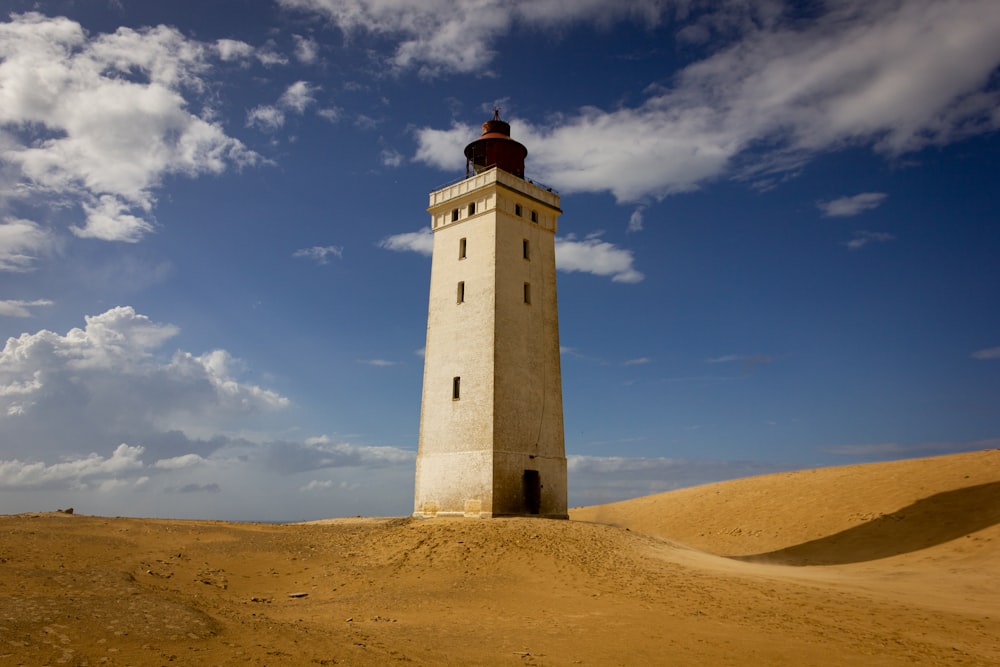 white and black lighthouse under blue sky during daytime