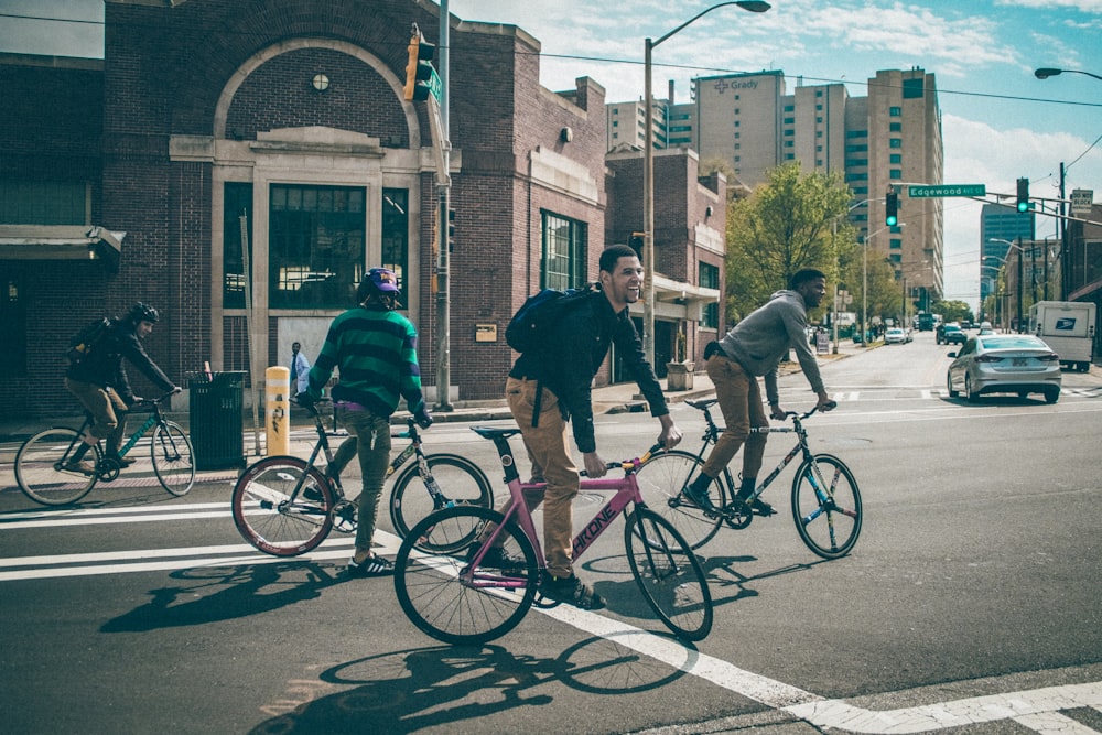 man in black jacket riding on bicycle during daytime