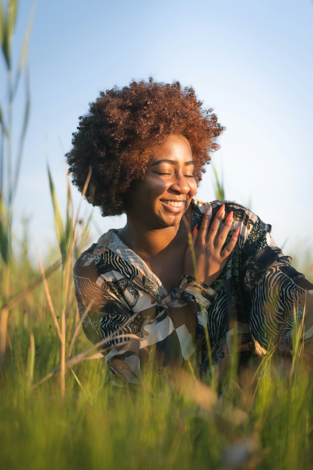 woman in black and white stripe shirt on green grass field